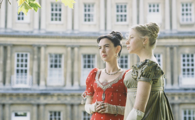 Two women dressed in Regency-style outfits